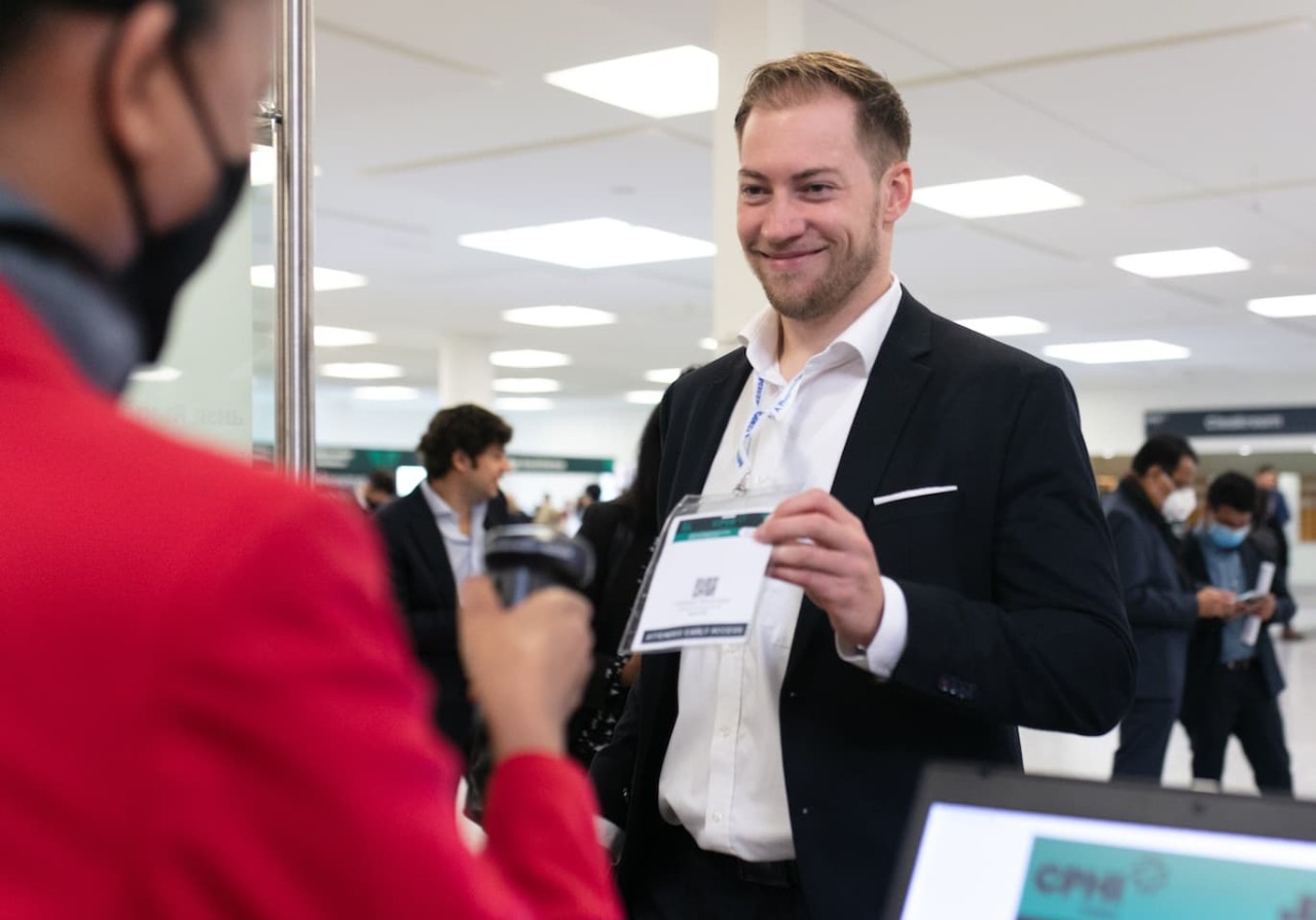 A visitor presenting their badge to be scanned